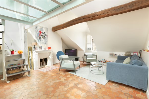 Living room with sofa, TV and decorative fireplace