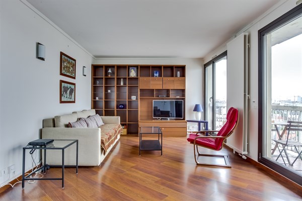 Living room with hardwood floors, sofa and chair