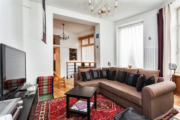 Living room with large windows, flat-screen TV